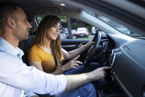 Driving instructor showing vehicle dashboard